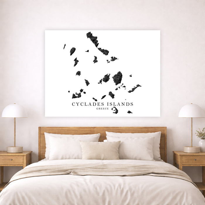Map of Cyclades Islands on a wall above a bed in a bedroom.