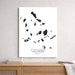 Map of Cyclades Islands on a white wall above a wooden shelf.