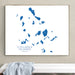 Framed map of Cyclades Islands, Greece on a wall above a white bench.