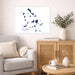 Living room with a map of Cyclades Islands on the wall, a vase with plants, and a wooden cabinet.