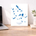 Map of Cyclades Islands on a desk with a laptop and plant