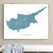 Framed map of Cyprus on a wall above a white bench.