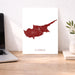 Map of Cyprus on a white background next to a laptop on a wooden desk.
