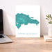 Map of the Dominican Republic on a white background next to a laptop on a wooden desk.