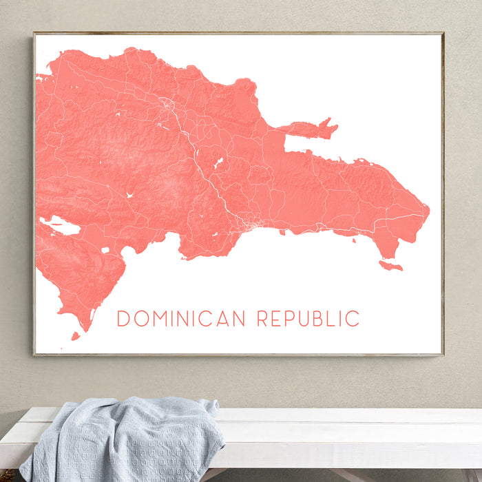 Map of the Dominican Republic in a frame on a wall above a white surface.