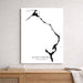 Map of Eleuthera, The Bahamas on a white wall above a wooden shelf.