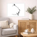 Living room with a gray sofa, wooden cabinet, and decorative items.