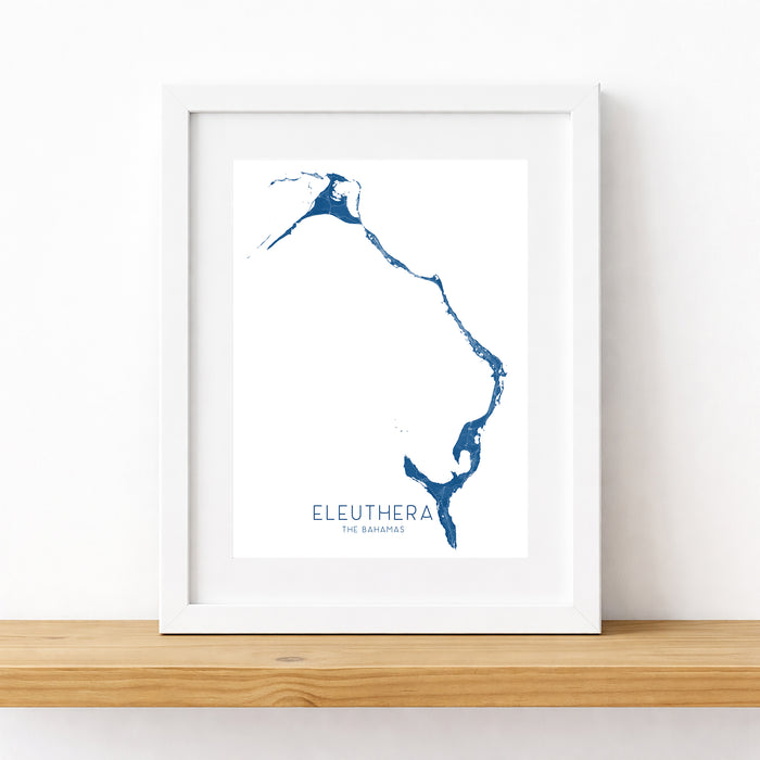 Framed map of Eleuthera, Bahamas on a white wall.