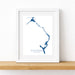 Framed map of Eleuthera, Bahamas on a white wall.