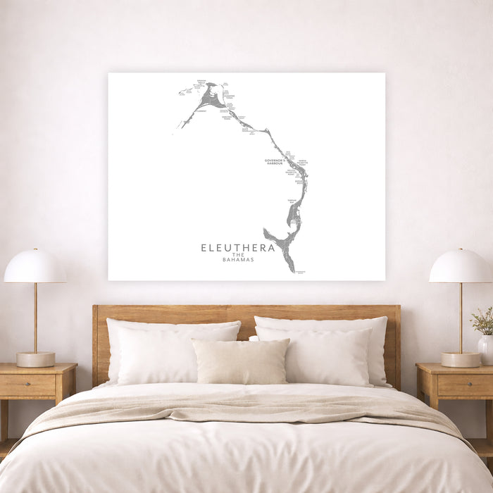 Map of Eleuthera, The Bahamas on a wall above a bed in a bedroom.