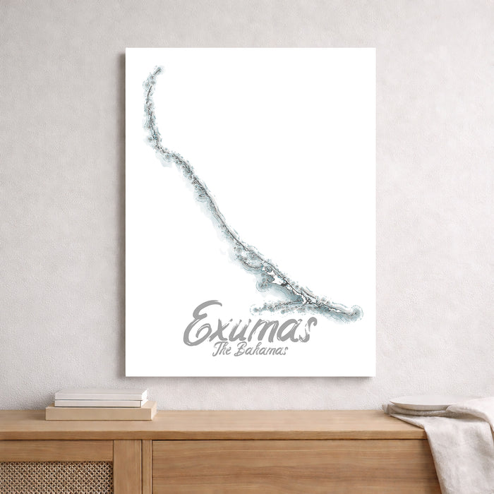 Map of Exumas, The Bahamas on a white wall above a wooden shelf.