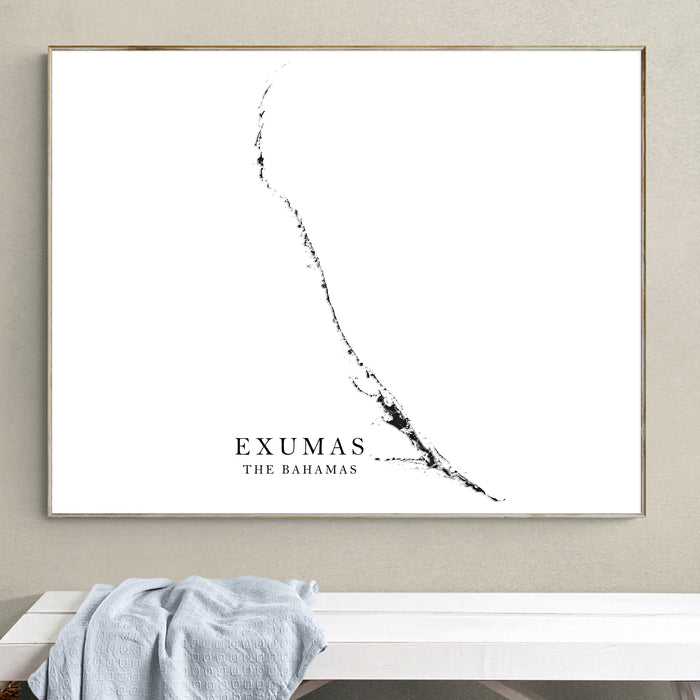 Framed map of Exumas, The Bahamas on a wall above a white bench.