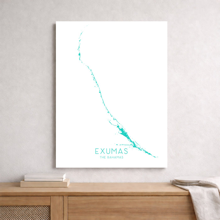 Framed map of Exumas on a wall above a wooden shelf.