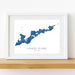 Framed map of Fishers Island, New York on a white wall.
