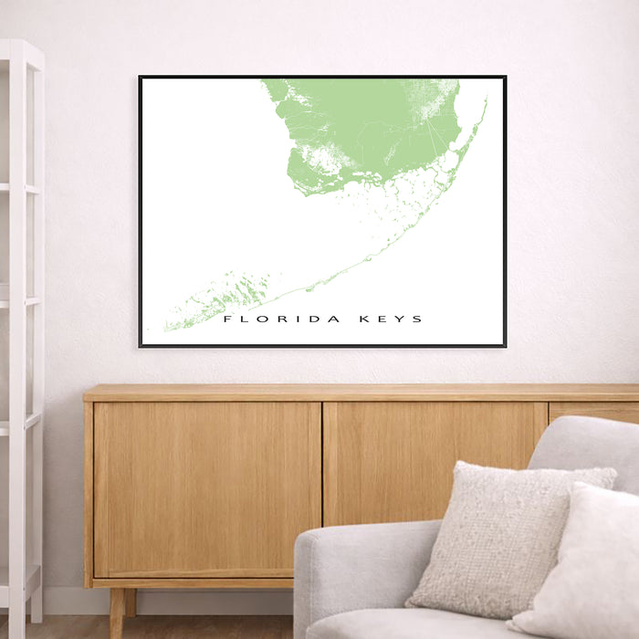 Map of Florida Keys framed on a wall above a wooden cabinet and sofa.
