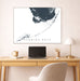 Map of Florida Keys on a wall above a desk with a laptop and lamp.