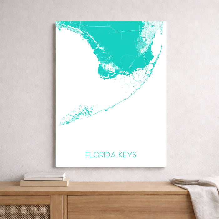 Framed map of the Florida Keys on a wall above a wooden shelf.