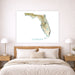 Map of Florida on a wall above a bed in a bedroom setting