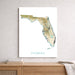 Map of Florida on a white wall above a wooden surface