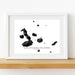 Framed map of the Galápagos Islands on a white wall.