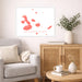 Living room with a map of Galápagos Islands on the wall, a gray sofa, wooden cabinet, and small table.