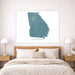 Map of Georgia on a wall above a bed in a bedroom setting