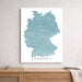 Map of Germany on a white wall above a wooden cabinet.