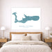 Map of Grand Cayman on a wall above a bed in a bedroom.