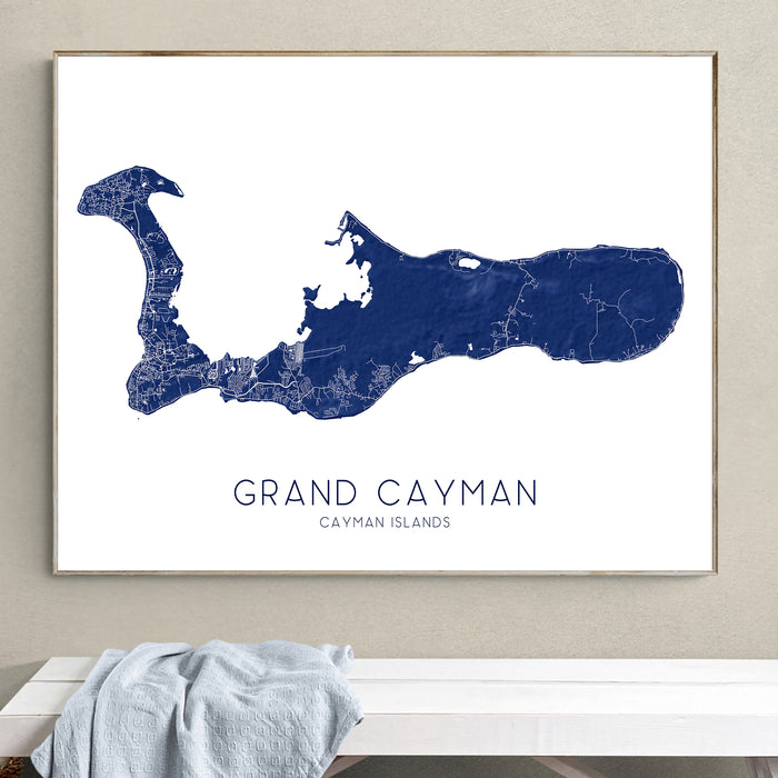 Framed map of Grand Cayman on a wall above a bench.