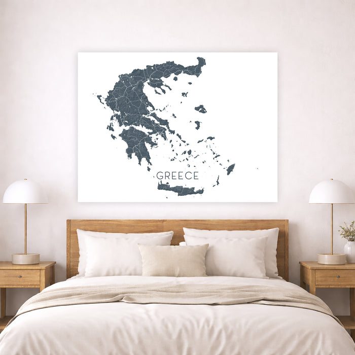 Map of Greece on a wall above a bed in a bedroom setting