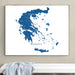 Framed map of Greece on a wall above a white bench.