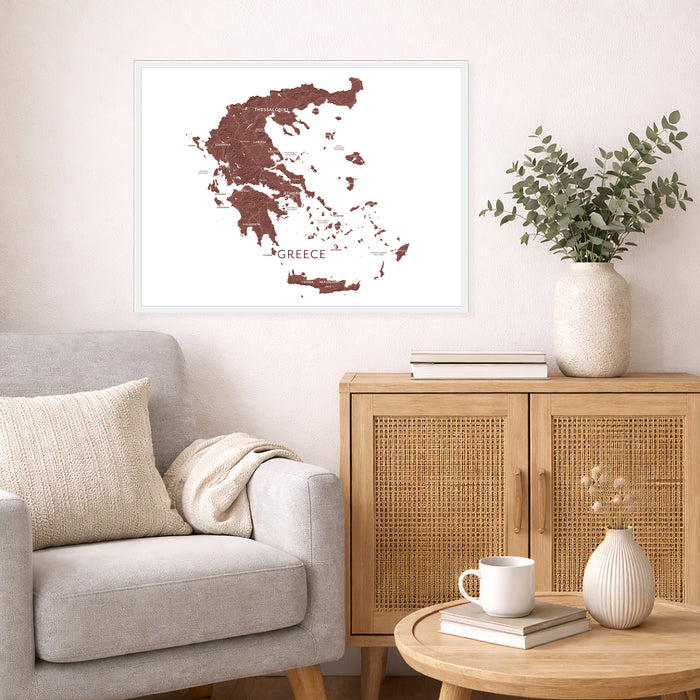 Living room with a map of Greece on the wall, a couch, and a wooden cabinet.