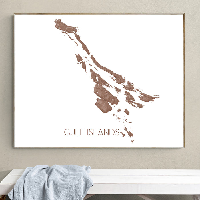 Framed map of the Gulf Islands on a wall above a white bench.