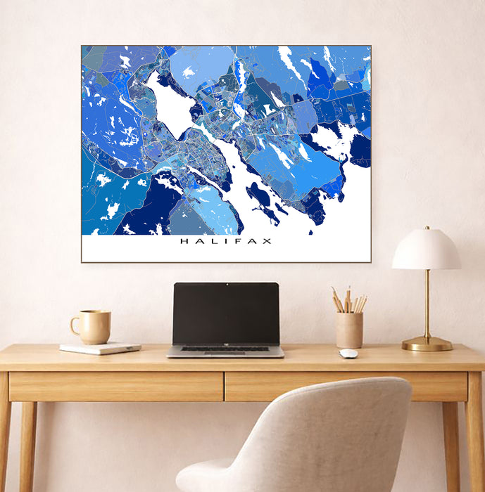 Map of Halifax on a wall above a desk with a laptop and office items.