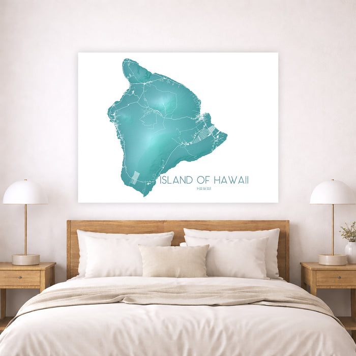 Framed map of the Island of Hawaii on a wall above a bed.