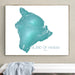 Framed map of the Island of Hawaii on a wall above a white bench.
