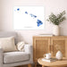 Living room with a gray sofa, wooden cabinet, and decorative items including a map of Hawaii.