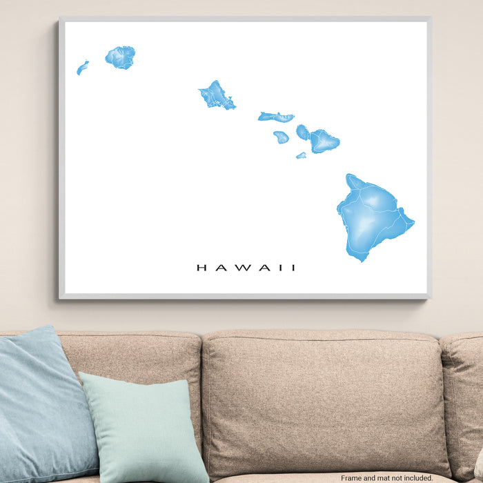 Framed map of Hawaii on a wall above a beige sofa with light blue pillows.
