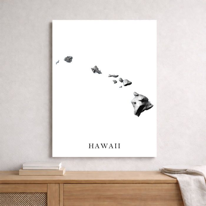 Framed map of Hawaii on a wall above a wooden console table.