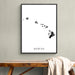 Framed map of Hawaii on a wall above a wooden bench with a blanket.