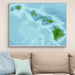 Framed map of Hawaii on a wall above a beige sofa with light blue pillows.