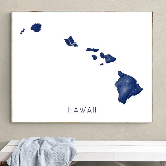 Framed map of Hawaii on a wall above a white bench.