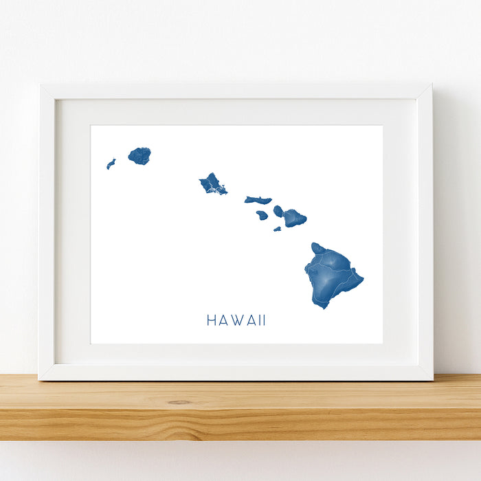 Framed artwork of a blue outline of Hawaii on a white background