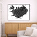 Framed map of Iceland on a wall above a wooden cabinet and sofa.