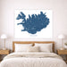 Map of Iceland on a wall above a bed in a bedroom setting