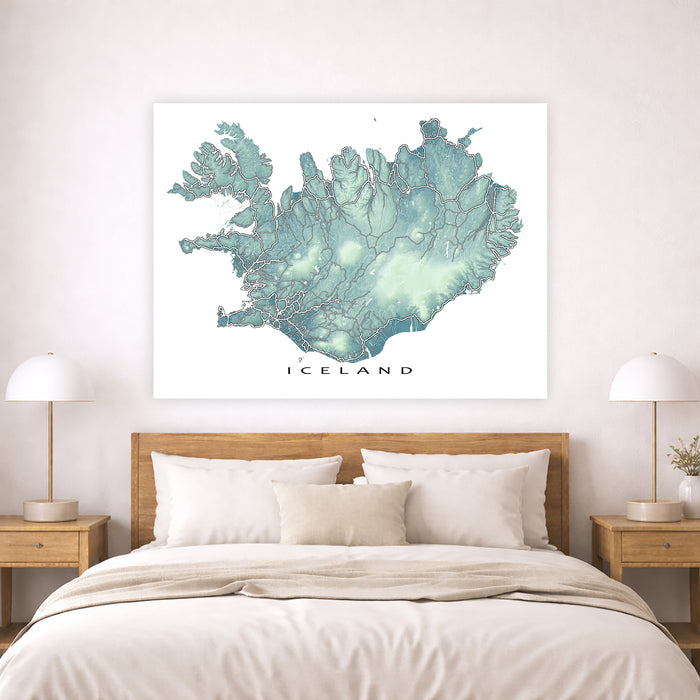 Map of Iceland on a wall above a bed in a bedroom setting