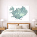 Map of Iceland on a wall above a bed in a bedroom setting