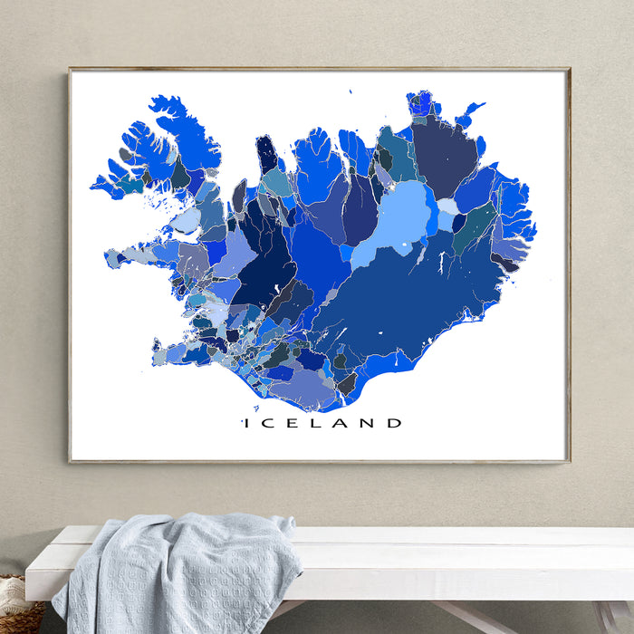 Framed map of Iceland on a wall above a white bench.