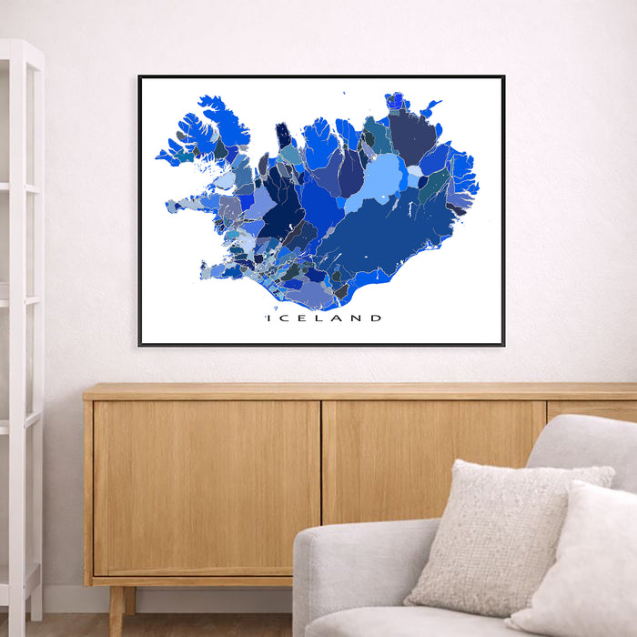 Framed map of Iceland on a wall above a wooden cabinet and sofa.
