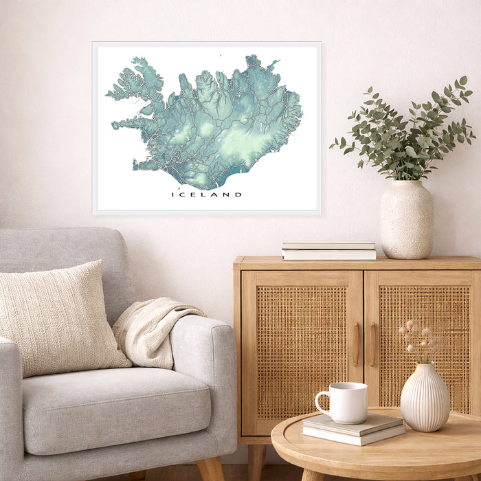 Living room with a map of Iceland on the wall, a vase with plants, and a wooden cabinet.